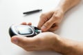 Close up of man checking blood sugar by glucometer