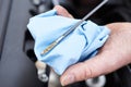 Close-Up Of Man Checking Car Engine Oil Level On Dipstick