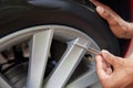 Close-Up Of Man Checking Car Tyre Pressure With Gauge Royalty Free Stock Photo
