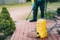Close up of man cleaning dirty red concrete pavement block Royalty Free Stock Photo