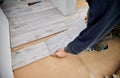Male worker hands laying laminate flooring in apartment. Royalty Free Stock Photo