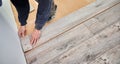 Male worker hands laying laminate flooring in apartment. Royalty Free Stock Photo