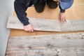 Male worker hands installing laminate floor in apartment. Royalty Free Stock Photo