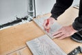 Male worker hands drawing line on laminate plank. Royalty Free Stock Photo