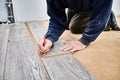 Male worker hands drawing line on laminate panel. Royalty Free Stock Photo