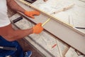 Male worker hands measuring wooden plank at construction site Royalty Free Stock Photo