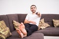 Close up man on the couch watching tv, changing channels at home Royalty Free Stock Photo