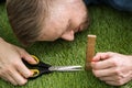 Man Using Measuring Scale While Cutting Grass