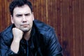 Close up of man with dark hair in black leather jacket Royalty Free Stock Photo