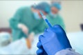 Close up man doctor holding syringe. Doctor in surgical mask and gloves preparing syringe for injection. Royalty Free Stock Photo