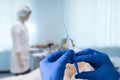 Close up man doctor holding syringe. Doctor in surgical mask and gloves preparing syringe for injection. Royalty Free Stock Photo