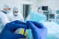 Close up man doctor holding syringe. Doctor in surgical mask and gloves preparing syringe for injection. Royalty Free Stock Photo