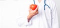 Close up Man doctor with stethoscope he is holding red heart on hand Royalty Free Stock Photo