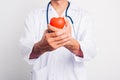 Close up Man doctor with stethoscope he is holding red heart on hand Royalty Free Stock Photo