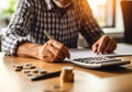 Close up man doing finance at home office, using calculator to calculate expenses on notebook, AI Generated