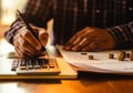 Close up man doing finance at home office, using calculator to calculate expenses on notebook, AI Generated