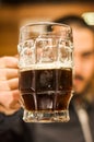 Close up of a man dolding a dark beer, delicious craft beer Booze Brew Alcohol Celebrate Royalty Free Stock Photo