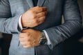 Close up of man dressing up and fastening buttons on shirt at home Royalty Free Stock Photo