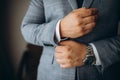 Close up of man dressing up and fastening buttons on shirt at home Royalty Free Stock Photo