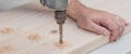 Man doing a home improvement project drilling into the wood. Royalty Free Stock Photo