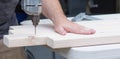 A man working on a home improvement project drilling into wood. Royalty Free Stock Photo