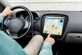 Close up of man driving car with gps navigator map Royalty Free Stock Photo