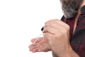 Close up, man dropping beard oil in his hand, beard care product for hipster