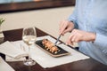 Close up of a man eating seafood at the restaurant