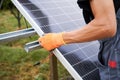 Close up of man engineer installing solar modules Royalty Free Stock Photo