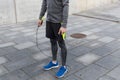 Close up of man exercising with jump-rope outdoors Royalty Free Stock Photo