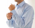 Close up of man fastening buttons on shirt sleeve Royalty Free Stock Photo