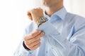 Close up of man fastening buttons on shirt sleeve Royalty Free Stock Photo