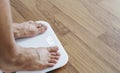 Close up a man feet on body scale checking body weight, dieting and lose weight concept Royalty Free Stock Photo