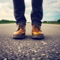 Close up man feet wearing shoes standing on asphalt road.AI generated