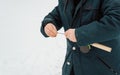 Close-up of man fisherman holding fishing rod, pulling line for winter fishing, outdoors Royalty Free Stock Photo