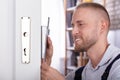 Close-up Of A Man Fixing Door Lock Royalty Free Stock Photo