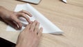 Close-up of man folding origami paper. Stock footage. Men`s hands are folded from white paper origami or airplane Royalty Free Stock Photo