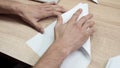 Close-up of man folding origami paper. Stock footage. Men`s hands are folded from white paper origami or airplane Royalty Free Stock Photo