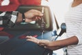 Close up man is giving keys to woman. African american family at car dealership. Father, mother and son near new car. Royalty Free Stock Photo