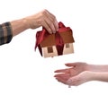 Close-up of man giving wooden house model tied with a bow to wom Royalty Free Stock Photo