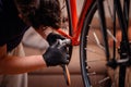 Man Using Bottom Bracket Tool on Red Bicycle Frame Royalty Free Stock Photo