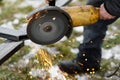 Close up of man grinding metal with circular grinder disc and electric sparks. Worker cutting metal with angle grinder for welding Royalty Free Stock Photo