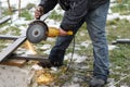 Close up of man grinding metal with circular grinder disc and electric sparks. Worker cutting metal with angle grinder for welding Royalty Free Stock Photo