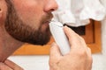 close up of a man grooming shaving and trim the beard with electric razor cutting mustache on the mirror Royalty Free Stock Photo