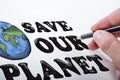 Close up of man hand drawing save the planet sketch on background. Earth day concept Royalty Free Stock Photo