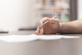 Close up of man hand filling out form. Working in the home office