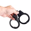 Close-up of man hand holding closed handcuffs, isolated on white Royalty Free Stock Photo