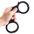 Close-up of man hand holding closed handcuffs, isolated on white Royalty Free Stock Photo