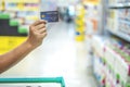 Close up of man hand holding credit card in supermarket, Finance concept. prepare for shopping online. copy space background for Royalty Free Stock Photo