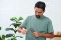 Close-up man hand mini coffee grinder holder man grinding coffee beans in same direction as clockwise, coffee beans are ground